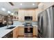 Bright and modern kitchen featuring stainless steel appliances, quartz countertops, and stylish pendant lighting at 16160 W Starlight Dr, Surprise, AZ 85374