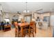 Spacious living area open to the dining room and kitchen, featuring modern lighting and wood floors at 16160 W Starlight Dr, Surprise, AZ 85374