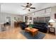 Inviting living room with wood flooring, leather seating, dining area, and access to the backyard at 16160 W Starlight Dr, Surprise, AZ 85374