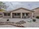 Well-kept backyard featuring desert landscaping, covered patio, and charming decorative elements at 16526 W Calle Lejos --, Surprise, AZ 85387