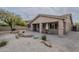 Charming backyard with desert landscaping, covered patio, and views of neighboring houses at 16526 W Calle Lejos --, Surprise, AZ 85387