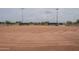 Detailed view of a smooth, red clay baseball infield showcasing the pitcher's mound and bases, ready for play at 16526 W Calle Lejos --, Surprise, AZ 85387