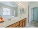 Well-lit bathroom with double sinks, a large mirror, and a combined shower and tub at 16526 W Calle Lejos --, Surprise, AZ 85387