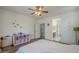 Charming bedroom with hardwood floors, a ceiling fan, and a playful storage unit; adjoining bath entrance at 16526 W Calle Lejos --, Surprise, AZ 85387