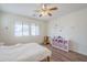 Well-lit bedroom features two large windows, wood-look floors, and a cute bookshelf at 16526 W Calle Lejos --, Surprise, AZ 85387