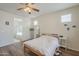 This bedroom features wood floors, a ceiling fan, and an en-suite bathroom at 16526 W Calle Lejos --, Surprise, AZ 85387