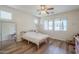 Bright bedroom featuring hardwood floors, abundant natural light, and a serene view from the large windows at 16526 W Calle Lejos --, Surprise, AZ 85387