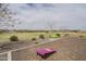 Open green space in the community park featuring cornhole boards and seating at 16526 W Calle Lejos --, Surprise, AZ 85387