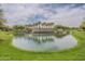 Beautiful community pond featuring a decorative island with palm trees, perfect for a relaxing walk at 16526 W Calle Lejos --, Surprise, AZ 85387