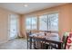 Sunlit dining area featuring a wooden table set, large windows, tile floors, and a view of backyard at 16526 W Calle Lejos --, Surprise, AZ 85387