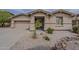 Inviting single-story home with neutral stucco exterior and desert landscaping, offering great curb appeal at 16526 W Calle Lejos --, Surprise, AZ 85387