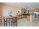 A light and bright kitchen with wood cabinets and stainless steel appliances overlooks a casual dining area at 16526 W Calle Lejos --, Surprise, AZ 85387