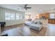 A spacious living room with wood-look floors, a sectional sofa, lots of natural light, connecting to the kitchen at 16526 W Calle Lejos --, Surprise, AZ 85387