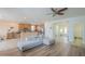 Living room showing an open floor plan with the kitchen, modern couch, and wood-look flooring at 16526 W Calle Lejos --, Surprise, AZ 85387