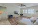Living room featuring a modern media center, plush seating, and bright natural light through large windows at 16526 W Calle Lejos --, Surprise, AZ 85387