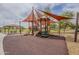 Colorful playground with slides and sunshades, offering a fun and safe recreational area for families at 16526 W Calle Lejos --, Surprise, AZ 85387
