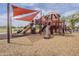 Colorful playground with slides, climbing features, and shade sails, providing a fun and safe environment for play at 16526 W Calle Lejos --, Surprise, AZ 85387