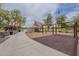 Community playground with swings, slides, climbing structures, and safe surfacing under mature trees, perfect for families at 16526 W Calle Lejos --, Surprise, AZ 85387