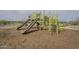Community playground features slides, climbing structures, and a soft mulch base at 16526 W Calle Lejos --, Surprise, AZ 85387