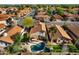 Aerial view features a backyard with a swimming pool, outdoor seating, and mature trees in a residential neighborhood at 1683 W Maplewood St, Chandler, AZ 85286
