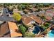 An aerial perspective of a property showcasing a swimming pool, covered patio, and verdant landscaping at 1683 W Maplewood St, Chandler, AZ 85286