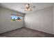Standard sized bedroom featuring neutral walls, carpet flooring, a ceiling fan and a sunny window at 1683 W Maplewood St, Chandler, AZ 85286