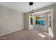 Bright dining area with tile flooring, a hanging light fixture, and backyard pool view at 1683 W Maplewood St, Chandler, AZ 85286