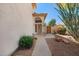 Inviting front entrance with a charming arched doorway, landscaped pathway, and desert accents at 1683 W Maplewood St, Chandler, AZ 85286