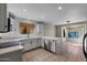 Bright kitchen with white cabinets, tile backsplash, and stainless steel appliances overlooking the breakfast nook at 1683 W Maplewood St, Chandler, AZ 85286
