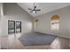 Spacious living room with tile flooring, neutral colors, large windows and sliding glass door to backyard at 1683 W Maplewood St, Chandler, AZ 85286