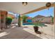 View of the pool from covered patio, showcasing outdoor space with lush greenery and privacy at 1683 W Maplewood St, Chandler, AZ 85286