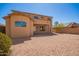 Exterior home view showcasing the large backyard and covered patio at 17458 W Wandering Creek Rd, Goodyear, AZ 85338