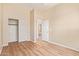 Neutral bedroom with wood floors, a double door closet, and a doorway to the upper floor at 17458 W Wandering Creek Rd, Goodyear, AZ 85338