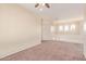Bonus room features neutral walls, lots of windows and cozy carpet at 17458 W Wandering Creek Rd, Goodyear, AZ 85338
