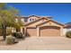 Beautiful two-story home with a three-car garage and desert landscaping at 17458 W Wandering Creek Rd, Goodyear, AZ 85338