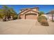 Charming two-story home with a three-car garage, desert landscaping, and solar panels at 17458 W Wandering Creek Rd, Goodyear, AZ 85338