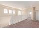 Upstairs hallway features natural light, neutral walls and plush carpet at 17458 W Wandering Creek Rd, Goodyear, AZ 85338
