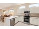 Kitchen area with stainless steel appliances and tile flooring at 17458 W Wandering Creek Rd, Goodyear, AZ 85338