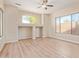 Serene bedroom with light walls, laminate floors, and large windows offering abundant natural light at 17458 W Wandering Creek Rd, Goodyear, AZ 85338