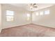 Spacious main bedroom with multiple windows and ceiling fan at 17458 W Wandering Creek Rd, Goodyear, AZ 85338
