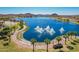 Scenic pond with fountains surrounded by lush landscaping and walking paths for a tranquil experience at 17458 W Wandering Creek Rd, Goodyear, AZ 85338