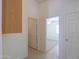 Bright hallway with multiple doorways and neutral tile flooring at 1778 E Bishop Pl, Casa Grande, AZ 85122