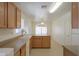 Well-lit kitchen featuring oak cabinets, modern appliances, and ample counter space overlooking the dining area at 1778 E Bishop Pl, Casa Grande, AZ 85122