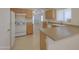 Well-lit kitchen featuring white appliances, light wood cabinetry, and tile floors at 1778 E Bishop Pl, Casa Grande, AZ 85122