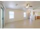 Spacious living room with tile floors, neutral paint, and natural light flowing from large windows at 1778 E Bishop Pl, Casa Grande, AZ 85122
