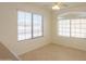 Inviting living room features bright windows with blinds and neutral tile flooring at 1778 E Bishop Pl, Casa Grande, AZ 85122