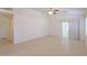 Bright living room with tile flooring, a ceiling fan, and a sliding glass door to the outside at 1778 E Bishop Pl, Casa Grande, AZ 85122