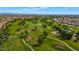 Breathtaking aerial view of lush golf course surrounded by homes and mature trees at 17806 N Becke Ln, Surprise, AZ 85374