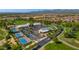 Aerial view of community clubhouse with tennis courts, swimming pool, and meticulous landscaping at 17806 N Becke Ln, Surprise, AZ 85374
