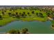 Scenic aerial view of a golf course with a tranquil pond and verdant green landscape at 17806 N Becke Ln, Surprise, AZ 85374